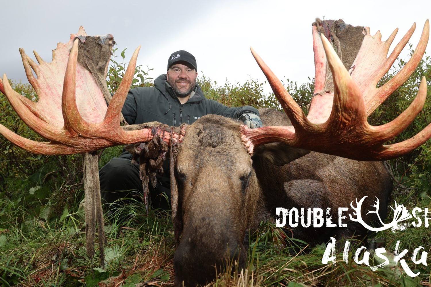 Hunter with a broad-palmed Alaska bull moose
