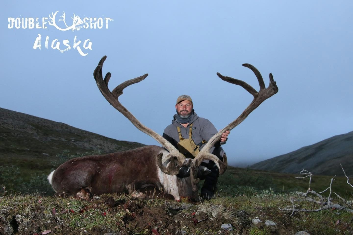 Hunter with an Alaska caribou