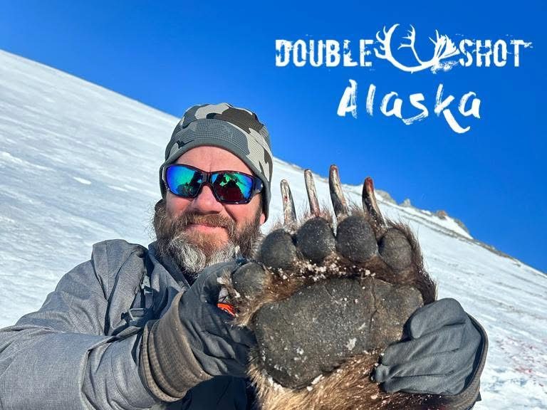 Hunter holding an Alaska bear paw